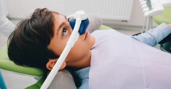 Child receiving nitrous oxide treatment during a sedation dentistry in Washington appointment at a dental office